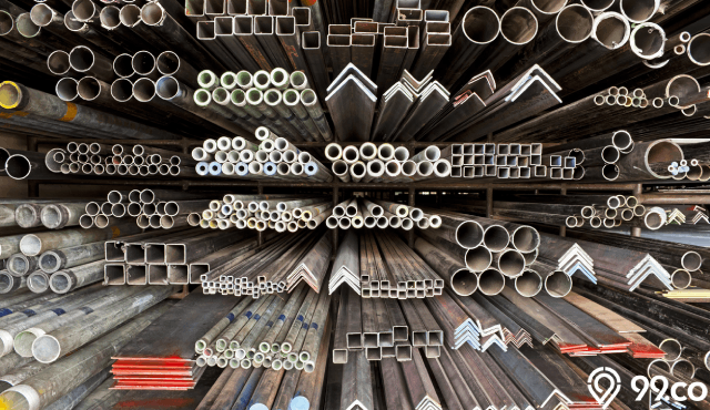 modern steel manufacturing facility interior with industrial machinery and steel beams, dramatic lighting