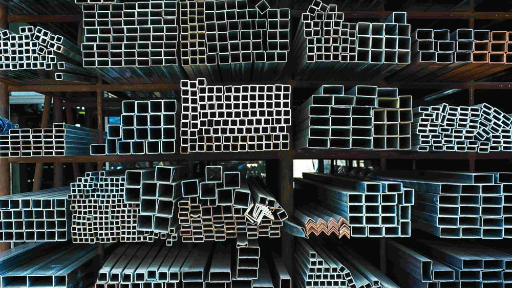 modern steel manufacturing facility interior with industrial machinery and steel beams, dramatic lighting